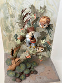 Mixed media sculpture of a person sitting on the branch of a tree, playing a sound bowl with small owls around them.