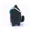 Ceramic sculpture of a stylized black cat character, with a blue skull face mask that is slightly tilted off its face.
