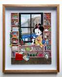Paper cut sculpture of a cartoon character with a geisha's hairstyle. She sits on a window sill looking out of a city bridge. She is surrounded by shelves full of Japanese and Giant Robot themed trinkets.