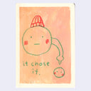 A minimalist artwork featuring a hand-drawn cartoon face with a red knit hat, green outline, and red cheeks on a peach background, with the text 'it chose it.' below.