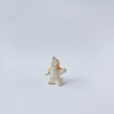 Very small ceramic sculpture of a white and orange tiger, leaning back on its hindlegs with its front legs up and its head thrown back.