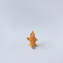 Very small ceramic sculpture of a white and orange tiger, leaning back on its hindlegs with its front legs up and its head thrown back.