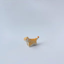 Very small ceramic sculpture of an orange and white tiger with gold detailing,