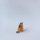 Very small glossy ceramic sculpture of a lion, sitting with a magpie on its back. The tiger has a carved poppy flower design on its back and gold detailing.