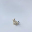 Very small glossy ceramic sculpture of a white tiger with blue stripes and subtle gold detailing.