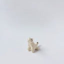 Very small glossy ceramic tiger sculpture, white with gold stripes and golden poppy flower design on its fur. It sits with a cute, happy expression.