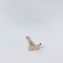 Very small glossy ceramic tiger sculpture, white with gold stripes and golden poppy flower design on its fur. It sits with a cute, happy expression.