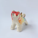 Glossy ceramic sculpture of a tiger with a white underbelly and rainbow coloring on its back with gold detailing.