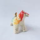 Glossy ceramic sculpture of a tiger with a white underbelly and rainbow coloring on its back with gold detailing.