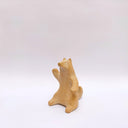 Brown clay ceramic figure of a wolf, sitting on its hind legs and waving.