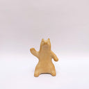 Brown clay ceramic figure of a wolf, sitting on its hind legs and waving.