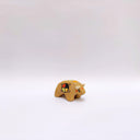 Small ceramic sculpture of a brown bison with 2 cream colored horns, red cheeks and a circular multicolor emblem on its side.