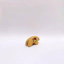 Small ceramic sculpture of a brown bison with 2 cream colored horns, red cheeks and a circular multicolor emblem on its side.
