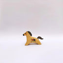 A small ceramic horse figurine in its natural brown clay coloring, decorated with black painted stripes on its mane and tail, and a circular multicolor emblem on its side, set against a plain light gray background.