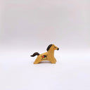 A small ceramic horse figurine in its natural brown clay coloring, decorated with black painted stripes on its mane and tail, and a circular multicolor emblem on its side, set against a plain light gray background.