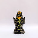 Ceramic figurine of a black bear, with its arms cradling 2 small animals - a miniature deer and a miniature buffalo. The bear has 2 ravens on its shoulders and a gold coin atop its head.