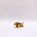 Small ceramic sculpture of a brown lion, with a flat, painted mane, and a multicolor emblem on the side of its body.