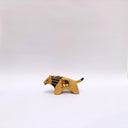 Small ceramic sculpture of a brown lion, with a flat, painted mane, and a multicolor emblem on the side of its body.
