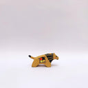 Small ceramic sculpture of a brown lion, with a flat, painted mane, and a multicolor emblem on the side of its body.