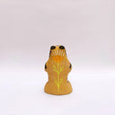 Beige ceramic sculpture of a wolf/tiger animal, sitting up on its hind legs, with its arms cradled together. There is a recession in its chest. It has subtle poppy flower designs on it.
