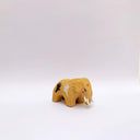 Small brown ceramic figurine of a prehistoric tusked elephant, with hands painting on its sides and a flower design on its back.