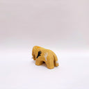 Small brown ceramic figurine of a prehistoric tusked elephant, with hands painting on its sides and a flower design on its back.