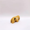 Small brown ceramic figurine of a prehistoric tusked elephant, with hands painting on its sides and a flower design on its back.