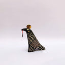 Ceramic sculpture of a black raven-like bird, with sgraffito line art, cream and red, on its feathers. It has a gold coin atop its head and a small key on a red string in its beak.