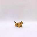 Small ceramic sculpture of a brown tiger, with black stripes on its back and tail and a circular 4-colored emblem on its side.