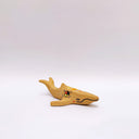 Small ceramic sculpture of a whale, with a long mouth and a circular 4-color emblem on the side of its body.