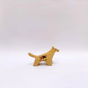 Small ceramic figurine of a brown wolf, with red cheeks and a circular 4-color emblem on its side.