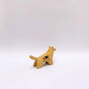 Small ceramic figurine of a brown wolf, with red cheeks and a circular 4-color emblem on its side.