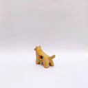 Small ceramic figurine of a brown wolf, with red cheeks and a circular 4-color emblem on its side.