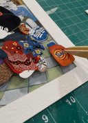 Illustration of a character at a laundromat loading into a laundry machine. 