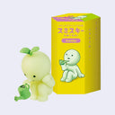 Figure of a Smiski, a simplified character with a round head and a stoic expression leaning down while holding a watering can. A sprout comes out atop its head.