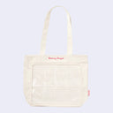 Cream colored tote bag with 8 clear slots in the front for small figures (such as Sonny Angel mini figures) to be placed. Pink embroidered "Sonny Angel" is written along the top.