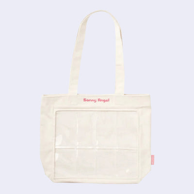 Cream colored tote bag with 8 clear slots in the front for small figures (such as Sonny Angel mini figures) to be placed. Pink embroidered "Sonny Angel" is written along the top.