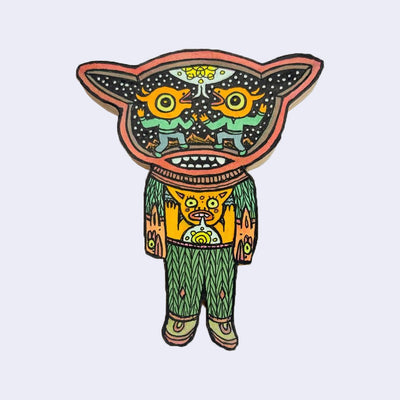 llustration made with many lines, giving it the feel of a folk art woodcut on a die cut wood panel of a character with knit sweater and pants, standing with its arms at its sides. Inside its head is a pair of orange characters, facing one another and sharing a speech bubble with a yellow geometric shape in it.