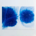 Abstract blue ink illustration in a watercolor patterning, dispersing the color fluidly.