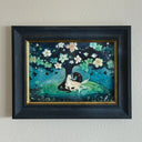 Illustration of a white and a black storybook style horse, laying under a tree with their bodies resting up against one another. The tree has many flowers and is on a mound of green grass.