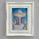 Framed artwork of a colorful carousel with seahorses and little shell children riding them on a gray wall.