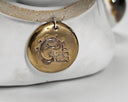 Close-up of a gold pendant with a design on a white background