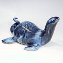 Ceramic sculpture of a sea monster akin to the Loch Ness Monster with dark blue glazing and light blue splattering.