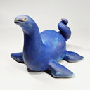 Ceramic sculpture of a sea monster akin to the Loch Ness Monster with bright blue glazing and a speckle finish.