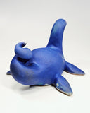 Ceramic sculpture of a sea monster akin to the Loch Ness Monster with bright blue glazing and a speckle finish.