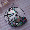 Stained glass hanging art of a Shiba Inu dog, silhouetted by its white markings and iridescent black coloring for its fur. 