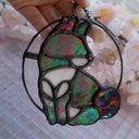 Stained glass hanging art of a Shiba Inu dog, silhouetted by its white markings and iridescent black coloring for its fur. 