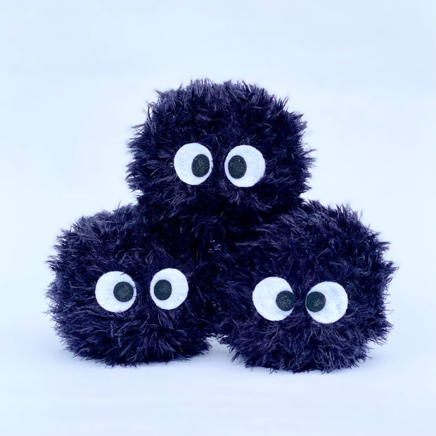 Stack of 3 fluffy, round plush dust sprites from My Neighbor Totoro with felt eyes.