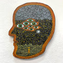 Die cut piece of wood in the shape of a head profile, painted to have 8 eyes and a starry sky background with rows of clouds and a cratered ground surface. A small creature walks on 2 legs on the surface.