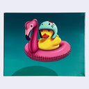 Painting of a yellow rubber duck sitting in a pink inflatable pool float with the head of a flamingo. The duck wears a light blue visor-less motorcycle helmet with the design of Hello Kitty on top. Background is a teal blue.